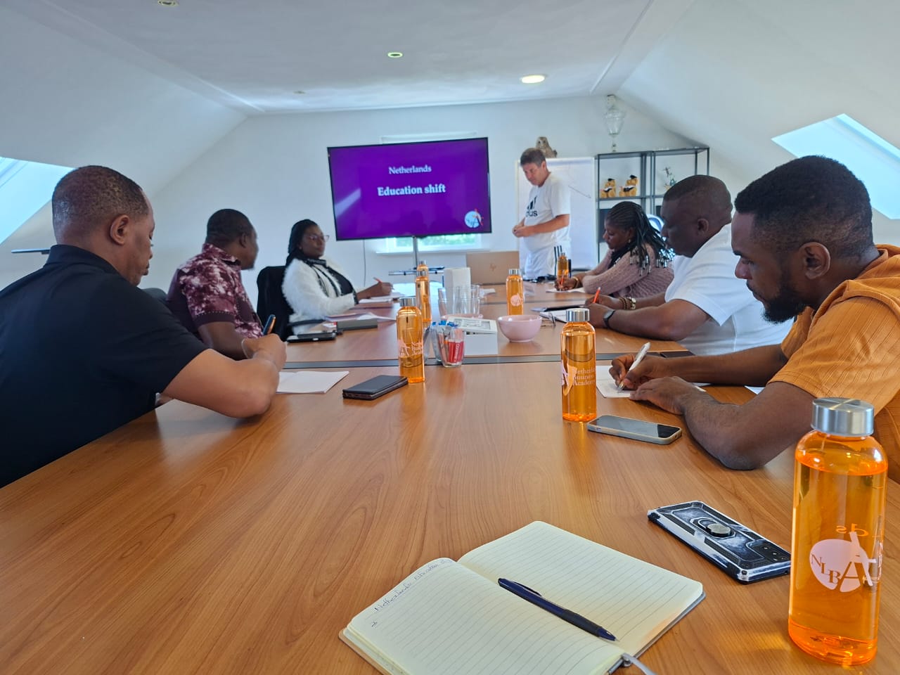 Training-for-trainers session on the Dutch education shift at NLBA, with FUNIC staff taking notes